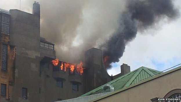 Firefighters battling fire in the upper windows of Charles Rennie Mackintosh's Glasgow School of Art (image courtesy BBC News; photo: John Stoddart)